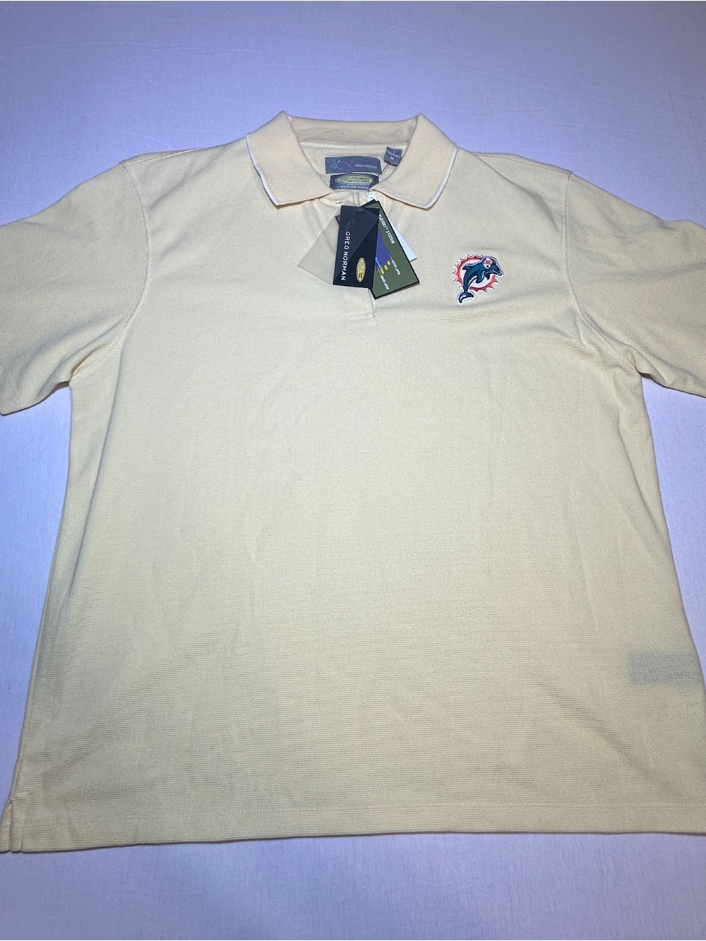 Greg Norman Collection Men's Polo in Pale Yellow with Dolphin Patch